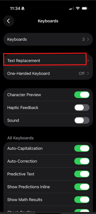 iPhone Keyboards settings screen with Text Replacement option highlighted in a red box